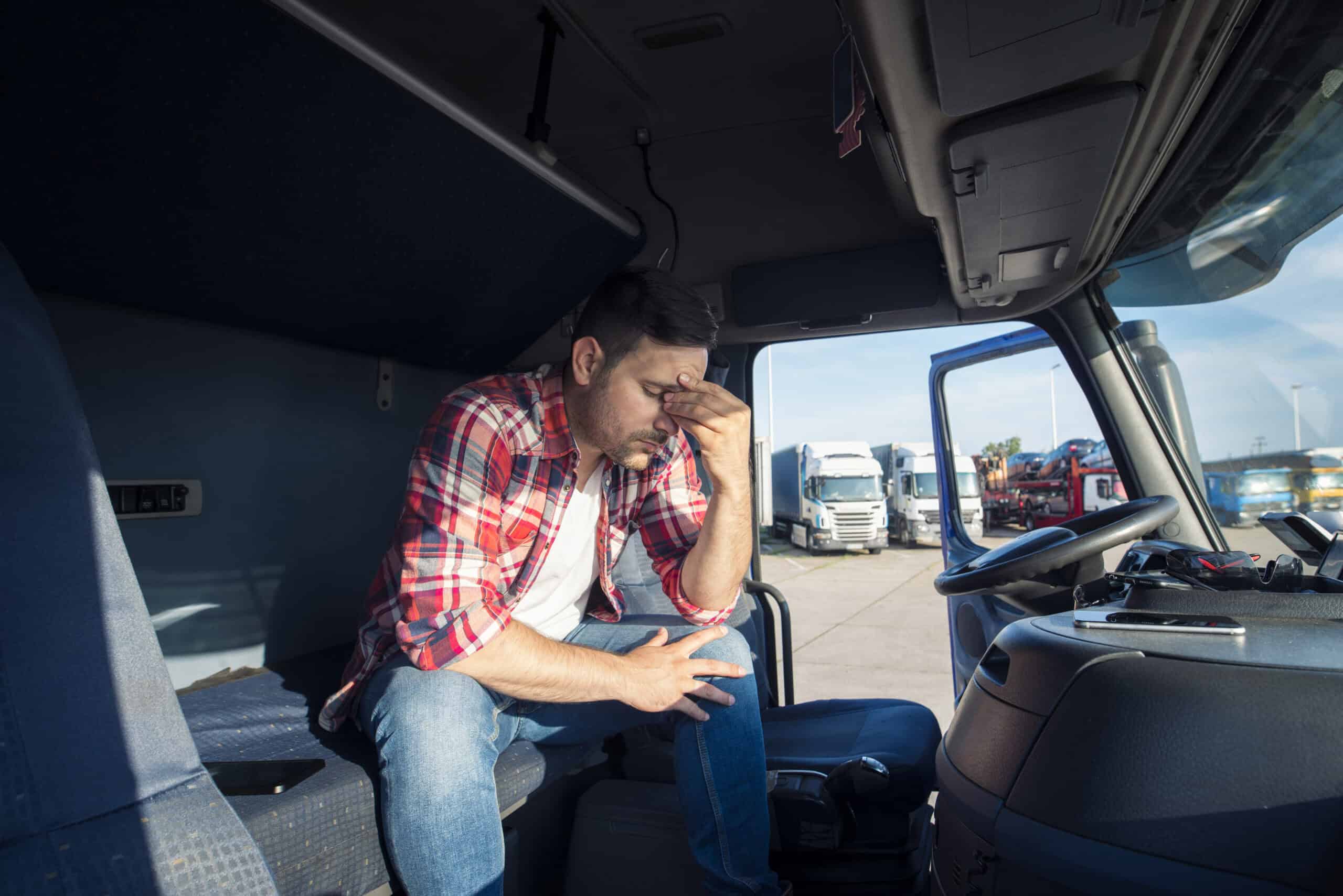 A truck driver sitting in the cabin
