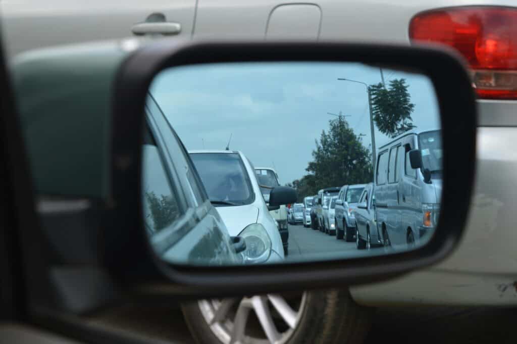 Car side mirror showing traffic